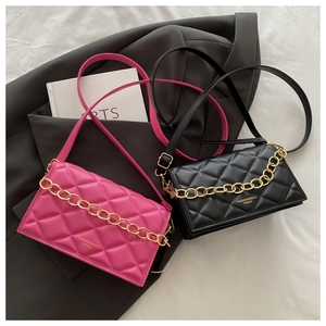 Detail of quilted leather mini bags in black and pink with decorative gold chains