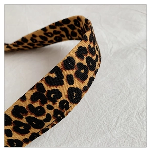 Macro shot showing high-density woven leopard print fabric texture and strap pattern