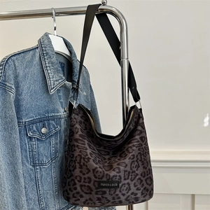 Grey leopard print canvas hobo bag with wide shoulder strap and fashion label detail