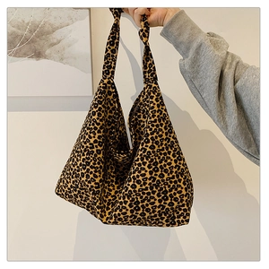 Close-up of leopard print canvas hobo bag with unique knotted handle for daily use