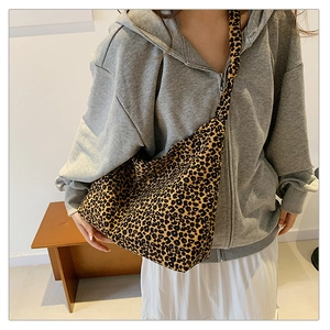 Detail of large leopard print hobo bag showing canvas texture and shoulder drape