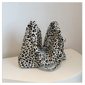 Detailed shot of large leopard print canvas tote bag with stylish knotted handle design