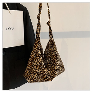 Close-up of leopard print canvas tote bag featuring stylish knotted handle design