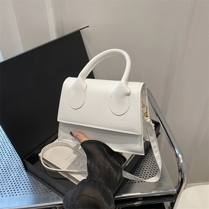Chic white mini leather handbag with curved handle and detachable crossbody strap
