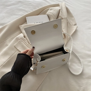 White faux leather flap handbag with gold magnetic buckles and interior view