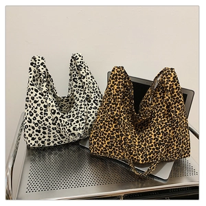 Close-up of leopard print canvas tote bags in brown and black-white color options