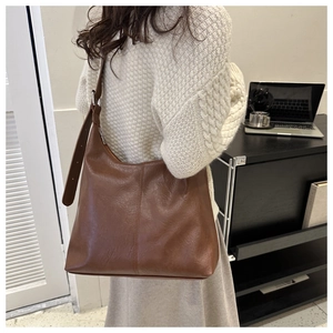 Retro brown large capacity PU leather tote bag shown on model in a cozy office setting