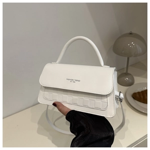 Detail of white PU leather bag with embossed checkerboard texture and fashion trend print