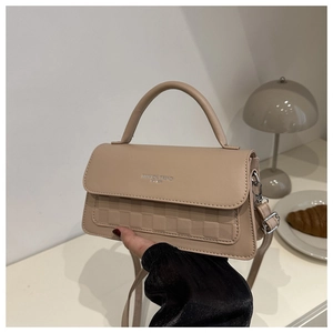 Detail of beige PU leather crossbody bag with checkered embossing and Fashion Trend logo