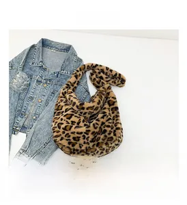 Detailed view of plush leopard print shoulder bag with soft faux fur texture for winter