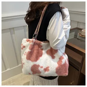 Détail du sac fourre-tout en peluche rose à motif vache et fines lanières