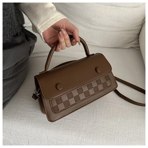 Close-up of brown PU leather bag showing woven checkerboard texture and buckles