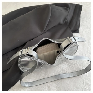 Detailed interior view of silver leather bag showing capacity with phone and wallet