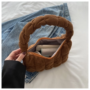Brown plush tote bag with diamond quilting, showing internal storage and zipper closure