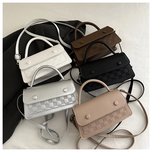Detail of color-block small square bags with woven texture in five chic autumn shades