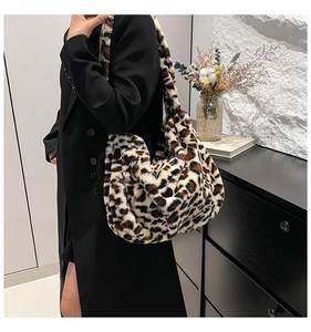 Detail shot of plush leopard print shoulder bag in faux fur with soft texture