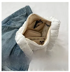 Internal view of a white quilted tote bag with spacious storage and zippered pocket