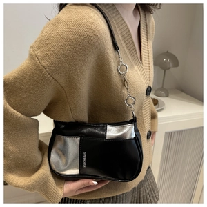 Detail of color-block shoulder bag with silver flower chain and FASHION & BAG lettering