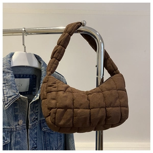 Close-up of dark brown quilted suede hobo bag with grid stitching and wide shoulder strap