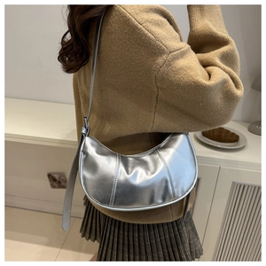 Silver metallic hobo bag detail with adjustable strap and stitched leather texture