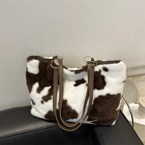 Chic cow print faux fur tote bag with brown PU shoulder straps and silver metal hardware