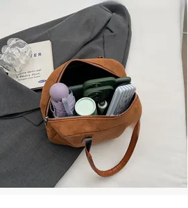 Interior view of brown faux suede Boston bag showing large storage capacity and items