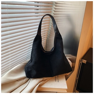 Detail of black suede hobo tote bag with a minimalist design for daily commuting