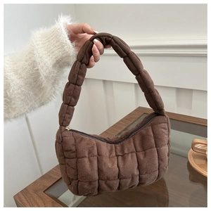 Close-up of deep brown quilted hobo bag with grid stitching and soft suede texture