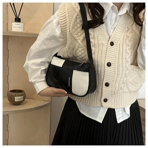Detail of black and white leather shoulder bag featuring Fashion & Bag text logo