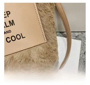 Macro shot of fluffy camel faux fur bag featuring stitched leather KEEP CALM AND COOL patch