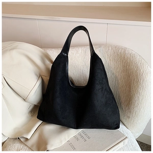 Detail of the high-capacity black hobo bag with a soft suede-like texture and leather trim