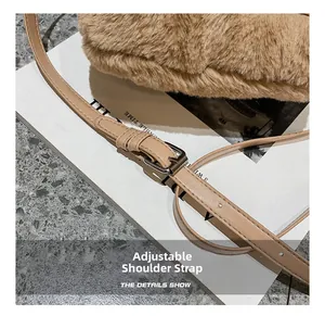 Detail of adjustable leather shoulder strap with silver buckle on camel plush tote bag
