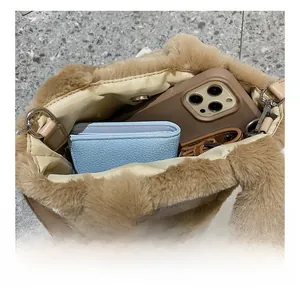 Top view of plush bucket bag interior showing capacity for phone and wallet with magnetic clasp