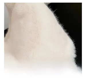 Detailed close-up of fluffy white faux fur texture on a luxury crossbody handbag