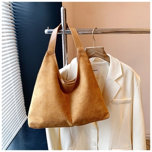Detail of camel suede hobo tote bag showing soft texture and large capacity