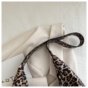 Close-up of leopard print tote bag strap and texture with soft lighting and aesthetic props