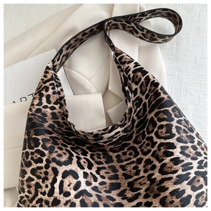Close-up of leopard print canvas tote bag texture with aesthetic prop styling