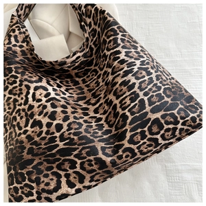 Detailed macro view of the vintage leopard print texture on a large capacity tote bag