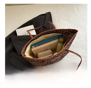 Spacious leopard print tote bag interior showing room for tablet, books and wallet