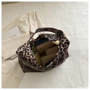 Top view of a large leopard print canvas tote bag showing spacious interior with daily items