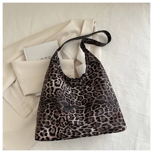 Large leopard print tote bag with soft texture on minimalist cream background