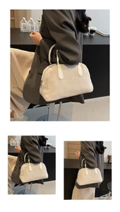 Close-up detail of off-white faux suede boston bag with premium leather handles