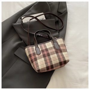 Detailed view of the plaid tote bag featuring classic check pattern and leather straps