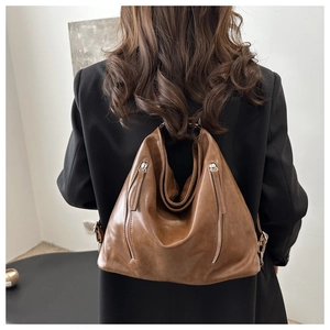 Detail of vintage brown hobo bag featuring double vertical zippers and premium PU leather