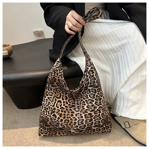 Close-up of leopard print tote bag texture on model with a stylish casual outfit