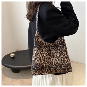 Fashionable leopard print tote bag styled with a minimalist outfit in an indoor setting