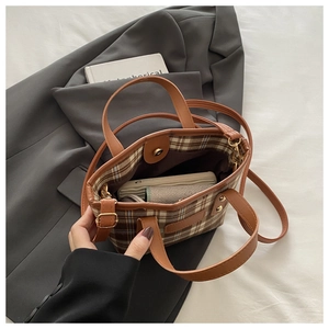 Detailed internal view of plaid tote bag showing ample space for phone and wallet items