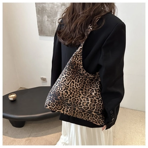 Detailed shot of large capacity leopard print tote bag styled on a female shoulder