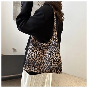 Detailed back view of casual leopard print hobo tote bag shown on model in studio