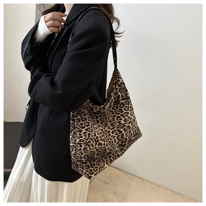 Detailed view of large leopard print tote bag styled with casual elegant outfit